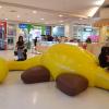 A dinosaur-shaped play structure for children in the mall