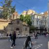 A very old church tucked between more modern buildings in Athens