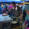 Apam balik, a fluffy Indonesian pancake stuffed with corn, peanuts and sugar