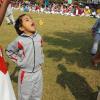 The younger kids have to eat the entire biscuit with no hands before they can run back to the start line