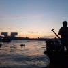 Vietnamese man on his boat at the crack of dawn
