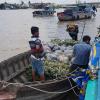 Two Vietnamese men sorting pineapples to bring to the mainland