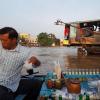 This man serves coffee from his small, wooden boat