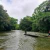 A local guide navigates a canoe up the Tutunendo River near Quibdó