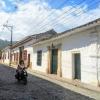 Many Colombians ride motorcycles as their main form of transportation, even along old cobblestone streets