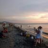 Tourists and locals alike enjoying an evening at the beach