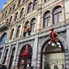 Sinterklaas' helper, Piet, swung from buildings