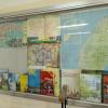 The back wall of the classroom has many interesting books and materials