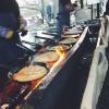 A vendor selling "Pannkakor," which are savory Swedish pancakes made by frying batter with pork! 