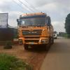 As I was walking to school, I noticed these large trucks unloading dirt on to one of the dirt roads that people drive on every day