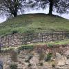 This is 'The Mound' - originally built to sustain the moat that surrounded the castle (moat: a body of water surrounding a building), which stopped intruders from being able to get to the castle, but now it just looks like a small hill 