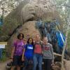 My friends and me next to a carving at a Buddhist monastery 