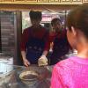 The chef whips up burger after burger for the many people waiting in line