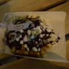 A delicious waffle covered in chocolate and marshmallows!