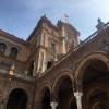 The center of Plaza de España in Seville has Spain's flag on the top of the nearest tower 