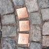 Copper bricks such as these are outside of the homes where Jewish citizens were taken to death camps during WWII, like Terezín in Czechia