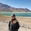 Abby in front of a beautiful, crystal clear lagoon