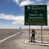 Abby standing under a sign marking the Tropic of Capricorn 