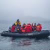 Where do you think the members of the expedition team are going in the Zodiac?