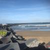 Massive black wave-breakers running out into the ocean off of San Sebastian