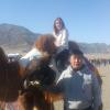 Posing on a camel while a Mongolian friend holds an eagle