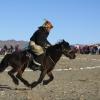 A man racing on a horse