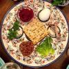 This seder plate features bitter herbs, marror, charoset, an egg, a shank bone and salt water