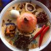 This seder plate has lots of unusual items on it, like a pomegranate and chili peppers