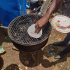 Prepping the grill with some oil, which is spread with a paper plate