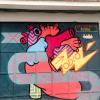 Question: What do you think this street art shows? Answer: It is a heart pumping in love and out hate.