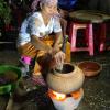 This woman is cooking rice seeds in order to make ombok, a traditional Khmer rice dish
