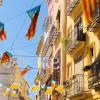 Valencian flags decorate the streets during Las Fallas. Valencia is the third largest city in Spain, after Madrid and Barcelona