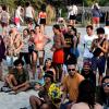 Taking a break from underground techno music, attendees of a nearby music festival started up a drum circle on the beach at sunset