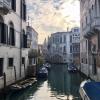 A view from a bridge overlooking one of the thousands of canals in the city of Venice