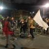 These people are chanting "Viva el paro nacional," which is a popular cheer meaning "Long live the national strike," while they hold a white flag representing peace