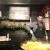 This market vendor makes fricassée comtoise, which is a French street dish with smoked sausage, cheese and sautéed potatoes