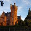 An ornate building resembling a castle glowing in the evening sun