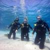 Sitting on your knees while scuba diving is harder than it looks because you must control your breathing so that you don't float to the surface