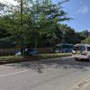 The small white bus that has "escolar" on the back is a typical school bus here