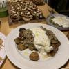 Mushrooms and potatoes with burrata, a type of gooey cheese.