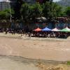 The group prepares to paint alongside the Mapocho River