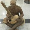 Here you see a man playing the "kora," a stringed musical instrument that is made of wood and a calabash (gourd).