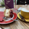 This is a cake with vanilla cream on the inside and raspberries on the outside, with a coffee too!