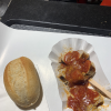 Here's a delicious "currywurst", or a sausage with a special curry sauce on it and served with a bread roll