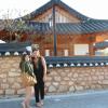 My friend Emily and I posing in front of a traditional house.