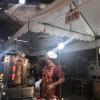 A man at the night market serving chicken doner!