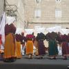 Locals doing a folk dance while wearing traditional costumes