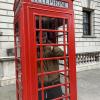 Friend inside London Phone Booth