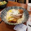 Cheesy donkatsu (crispy fried pork) over delicious sesame-flavored rice