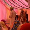 At a Sikh ceremony, the bride and groom walk around the Guru Granth Sahib (religious text) four times, and then it becomes official! 